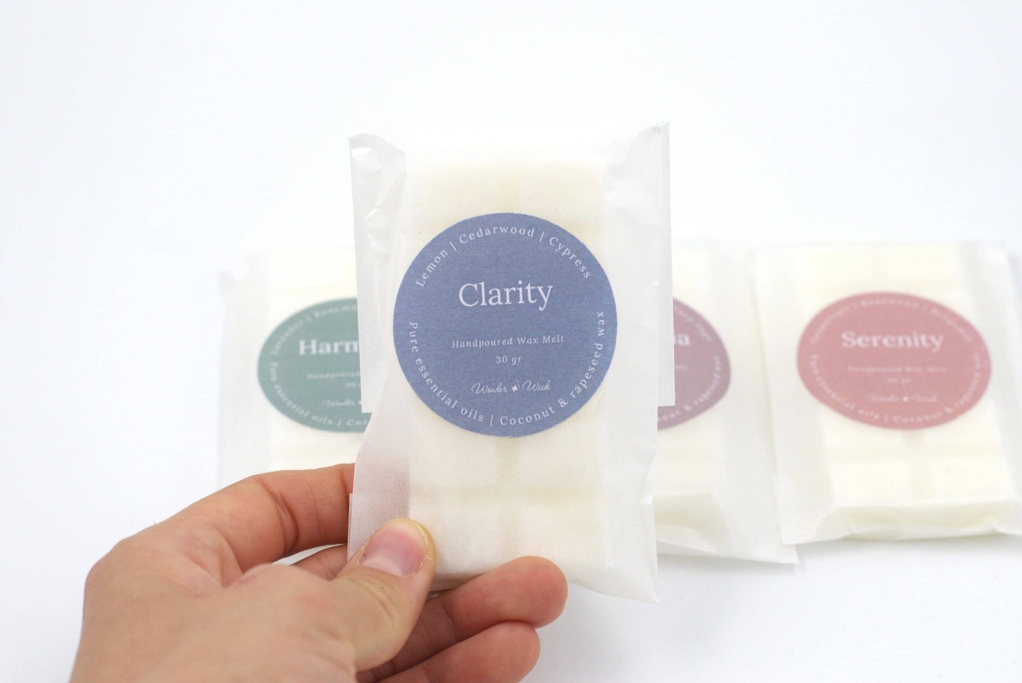 Close-up of Clarity essential oil wax melt in eco-friendly packaging, highlighting lemon, cedarwood, and cypress scent for a fresh, focus-enhancing aroma.