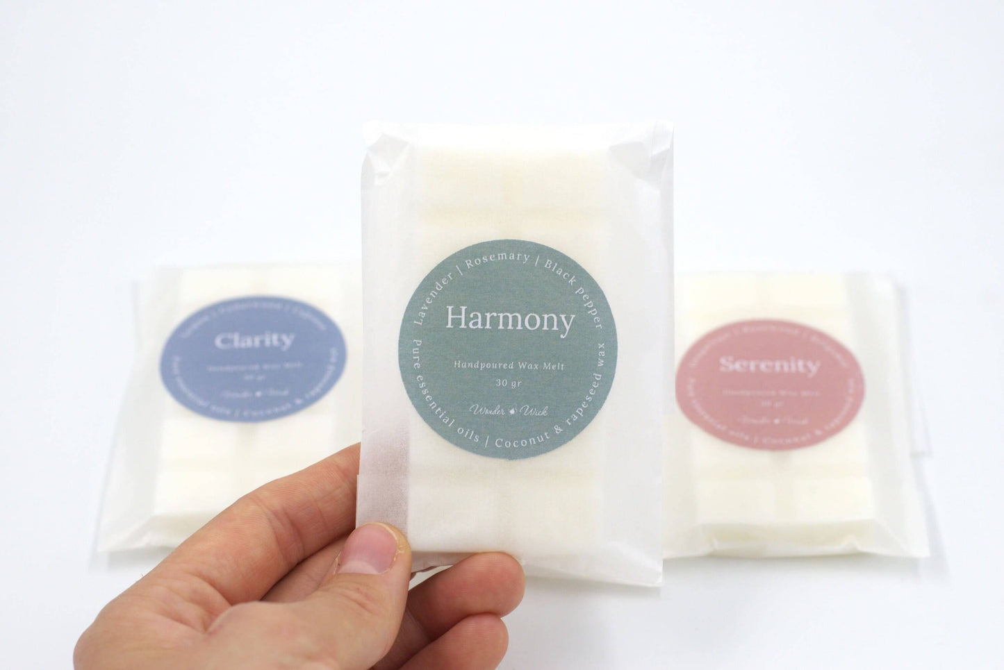 Close-up of Harmony essential oil wax melt in eco-friendly packaging, highlighting lavender, rosemary, and black pepper scent for a calming, stress-relieving effect