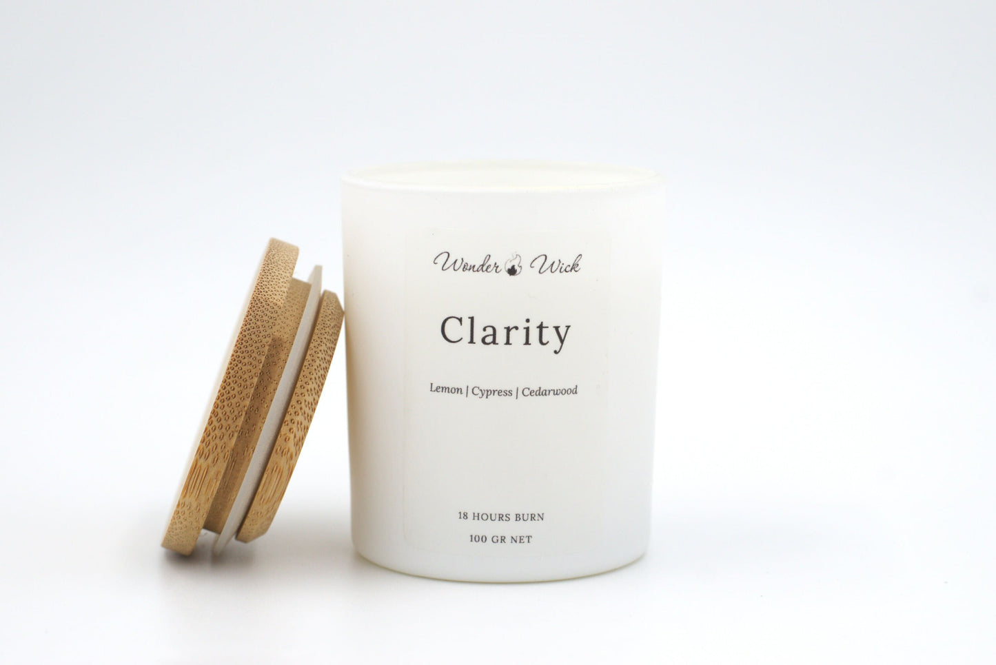 Clarity 18-hour burn candle with bamboo lid off, featuring a blend of lemon, cypress, and cedarwood for a refreshing, focus-enhancing aroma.