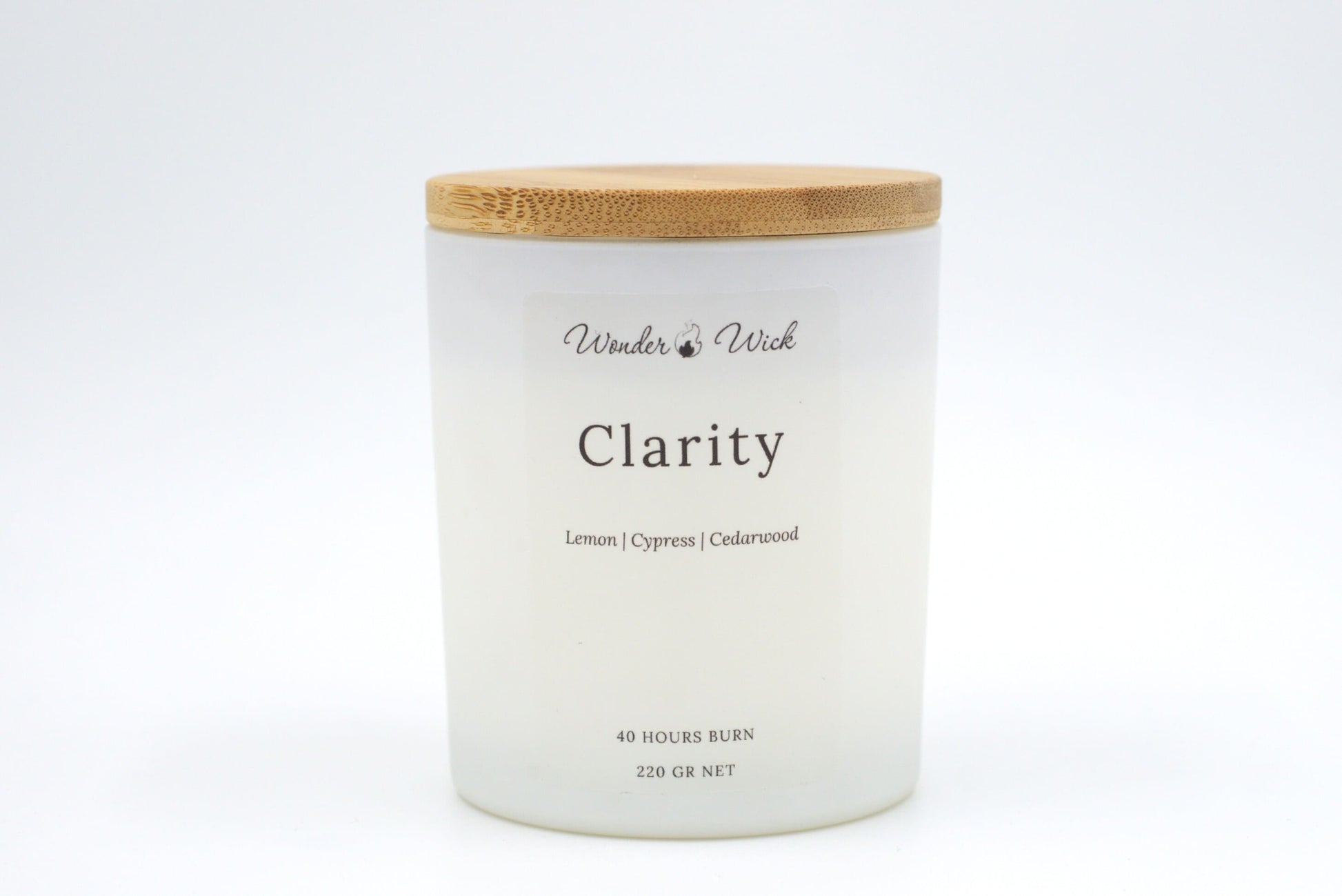 Clarity 40-hour burn candle with bamboo lid on, showcasing a sleek, minimalistic design paired with a grounding, citrusy scent.