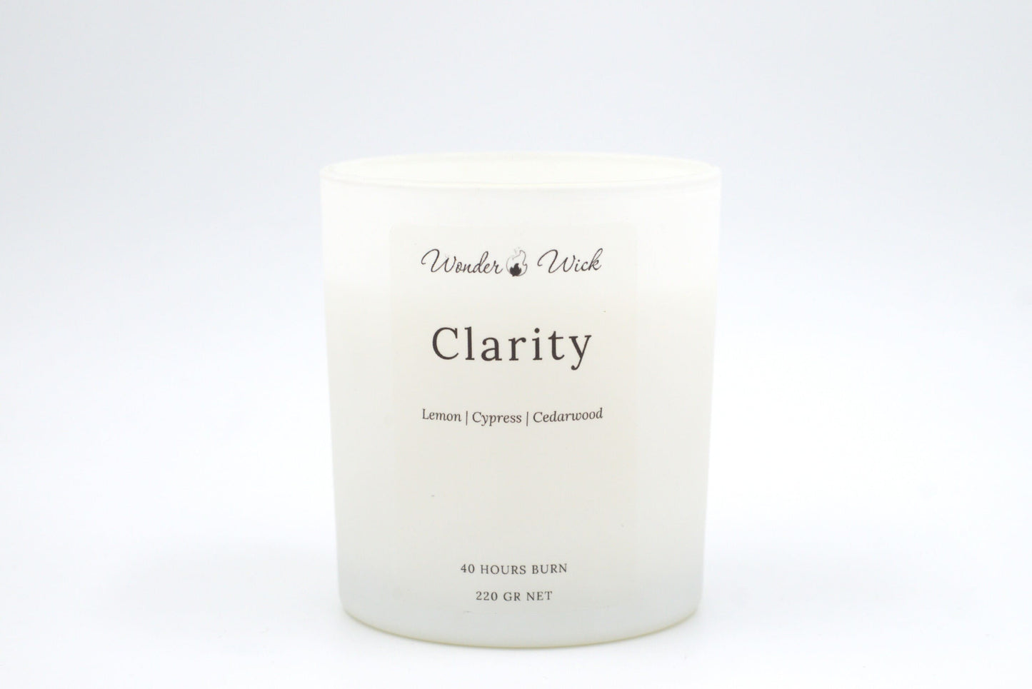 Clarity 40-hour burn candle without lid, revealing the candle’s simple aesthetic and scent of lemon, cypress, and cedarwood to boost concentration.