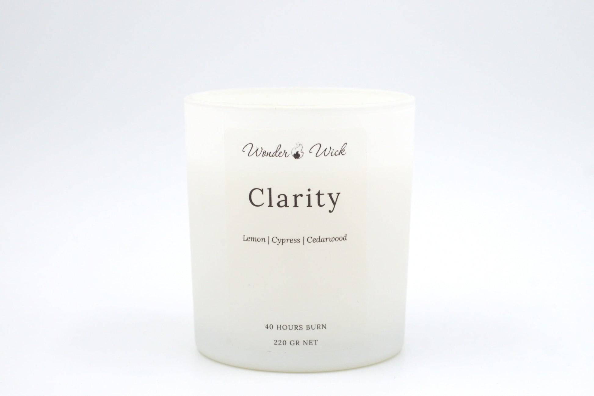 Clarity 40-hour burn candle without lid, revealing the candle’s simple aesthetic and scent of lemon, cypress, and cedarwood to boost concentration.