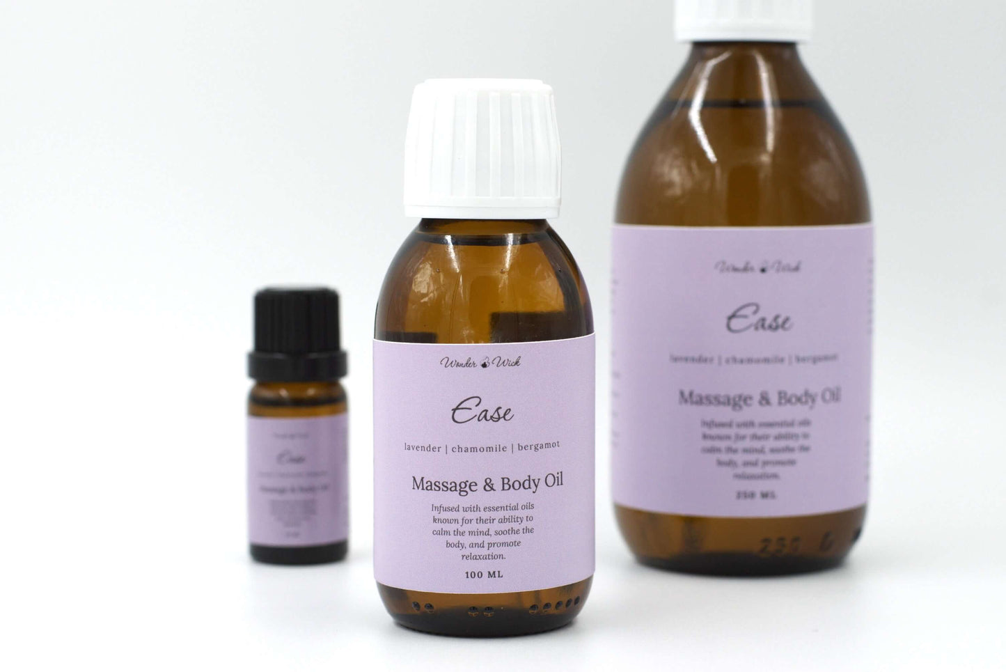 Wonder Wick Ease relaxing massage oil for sleep in a 100ml amber bottle. The bottle features a lavender-colored label with the essential oil blend: lavender, chamomile, and bergamot