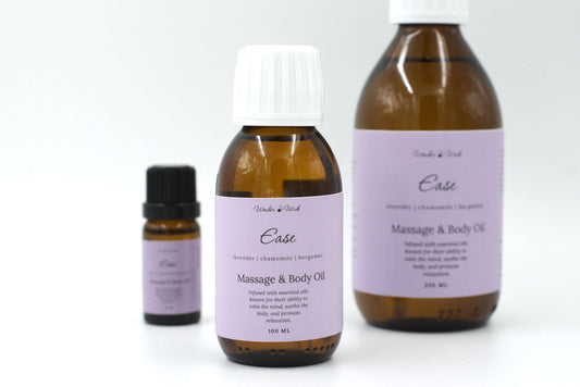 Wonder Wick Ease relaxing massage oil for sleep in a 100ml amber bottle. The bottle features a lavender-colored label with the essential oil blend: lavender, chamomile, and bergamot