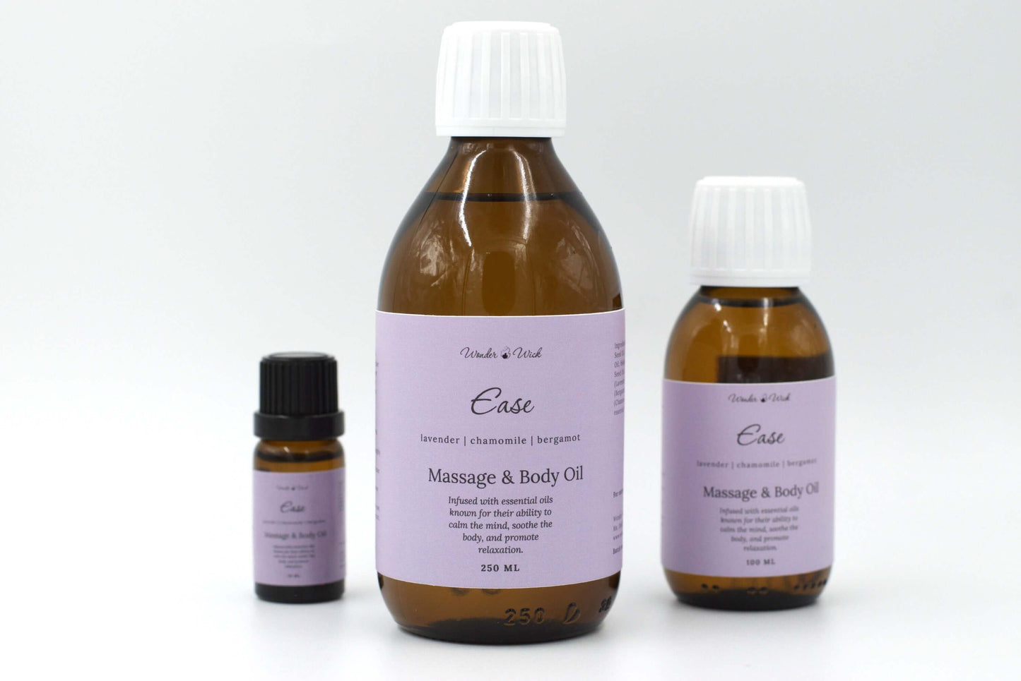 Wonder Wick Ease lavender massage oil product for sleep lineup, showcasing 10ml, 100ml, and 250ml bottles. Each bottle has a lavender-colored label listing the essential oils used: lavender, chamomile, and bergamot.