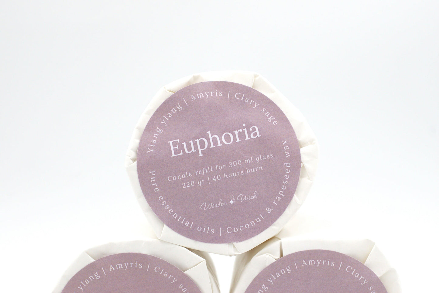 Euphoria candle refill for 300 ml glass with 40 hours burn time, wrapped in eco-friendly packaging with a label showing ylang ylang, clary sage, and amyris essential oils.