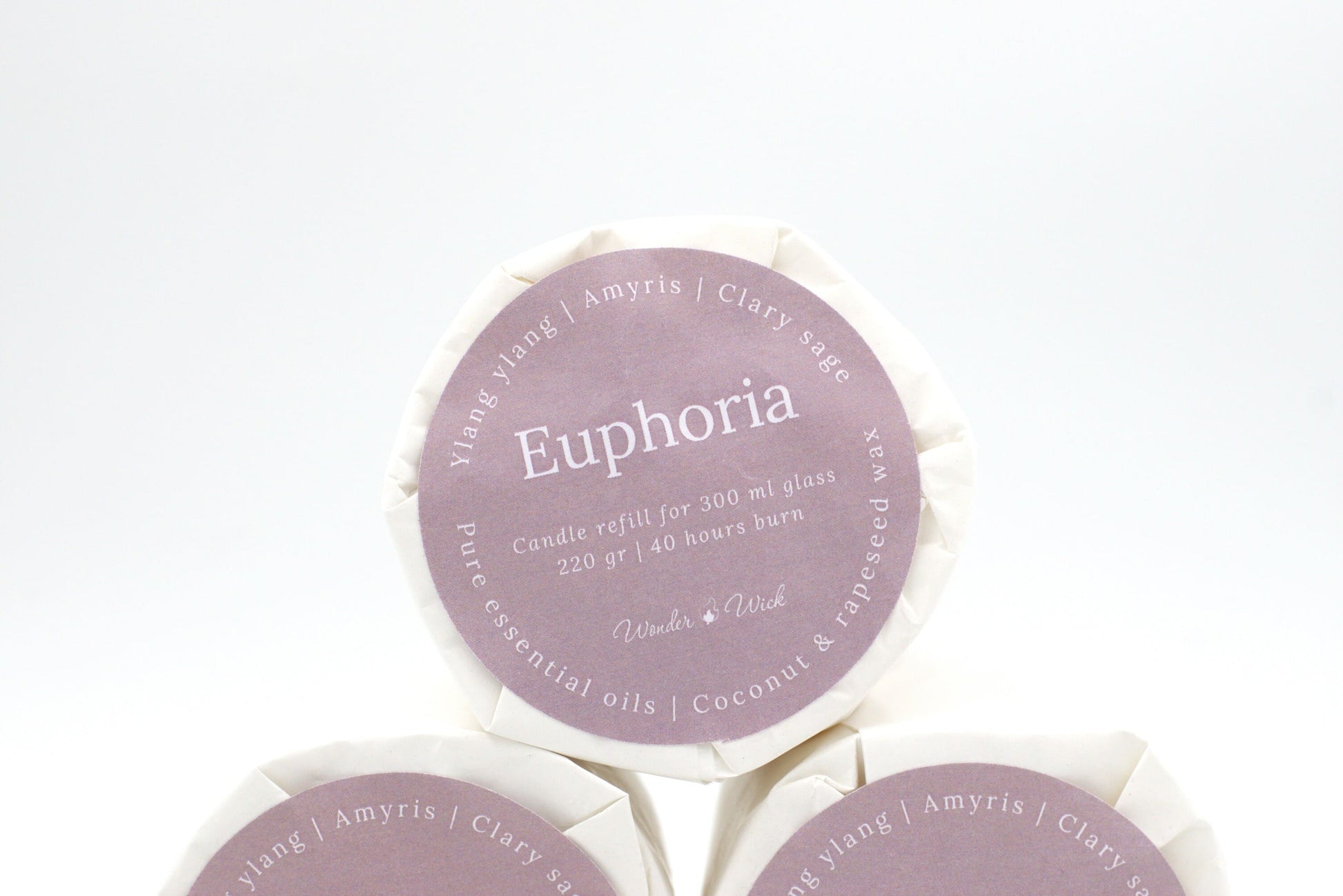 Euphoria candle refill for 300 ml glass with 40 hours burn time, wrapped in eco-friendly packaging with a label showing ylang ylang, clary sage, and amyris essential oils.