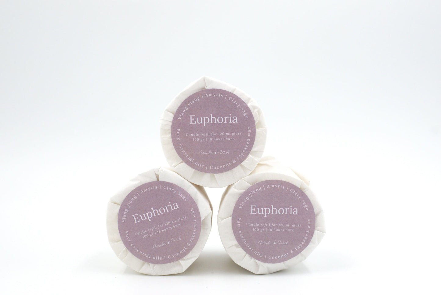 Three Euphoria candle refills for 120 ml glass, stacked to display eco-conscious packaging with 18-hour burn time details, and ingredients like ylang ylang, clary sage, and amyris.