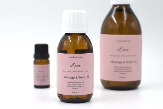 Wonder Wick's Love romantic massage oil for couples with essential oils, featuring a prominent 100 ml bottle, alongside a 250 ml bottle and a smaller sample size. Infused with ylang ylang, amyris, and clary sage essential oils, known for their ability to awaken desire and deepen int