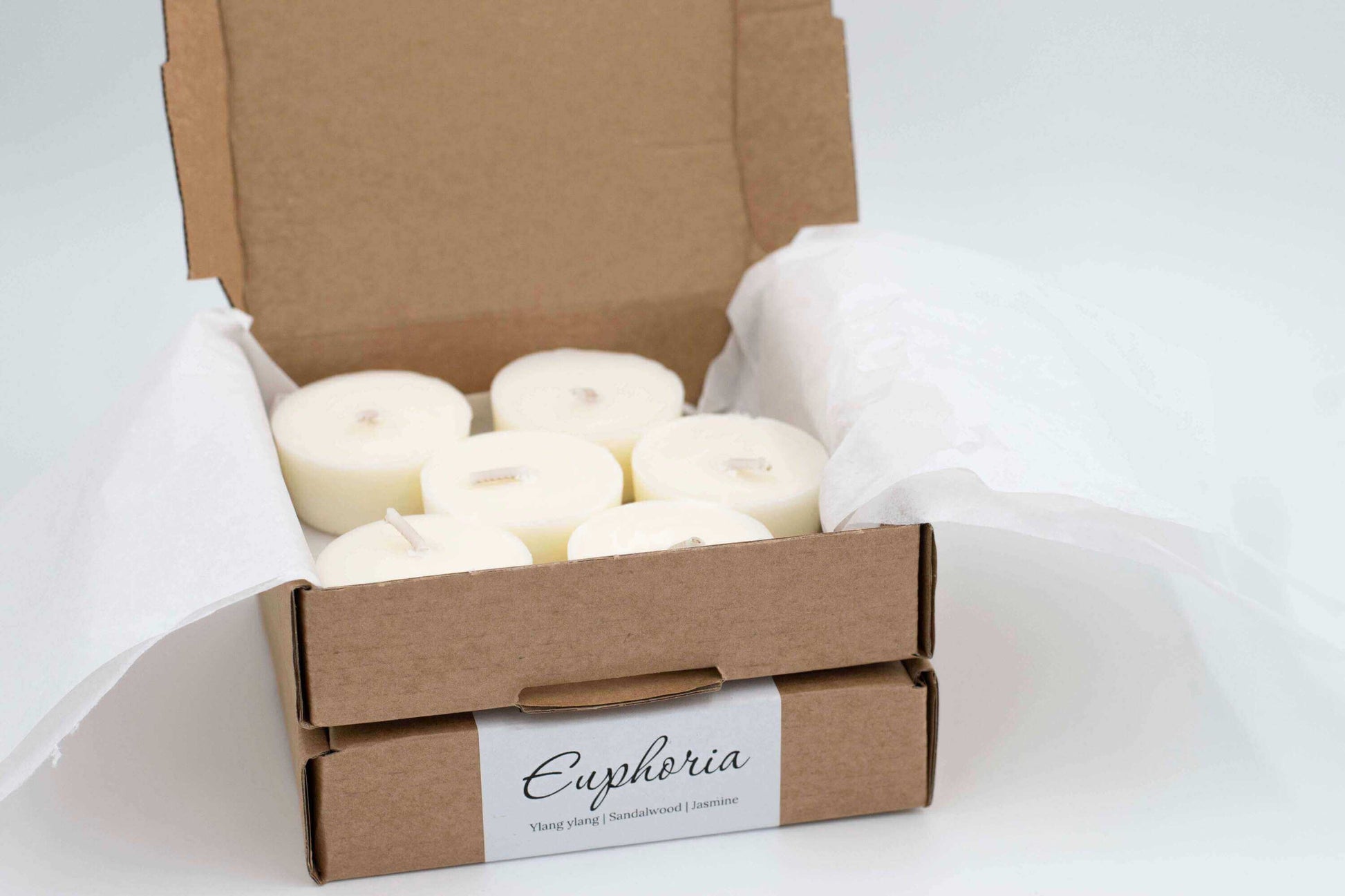 6-pack of Euphoria scented tea light candles made with ylang-ylang, jasmine, and sandalwood, eco-friendly and refillable in a cardboard box with tissue paper