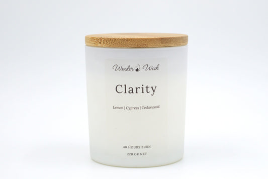 Clarity 40-hour burn candle with bamboo lid on, showcasing a sleek, minimalistic design paired with a grounding, citrusy scent.