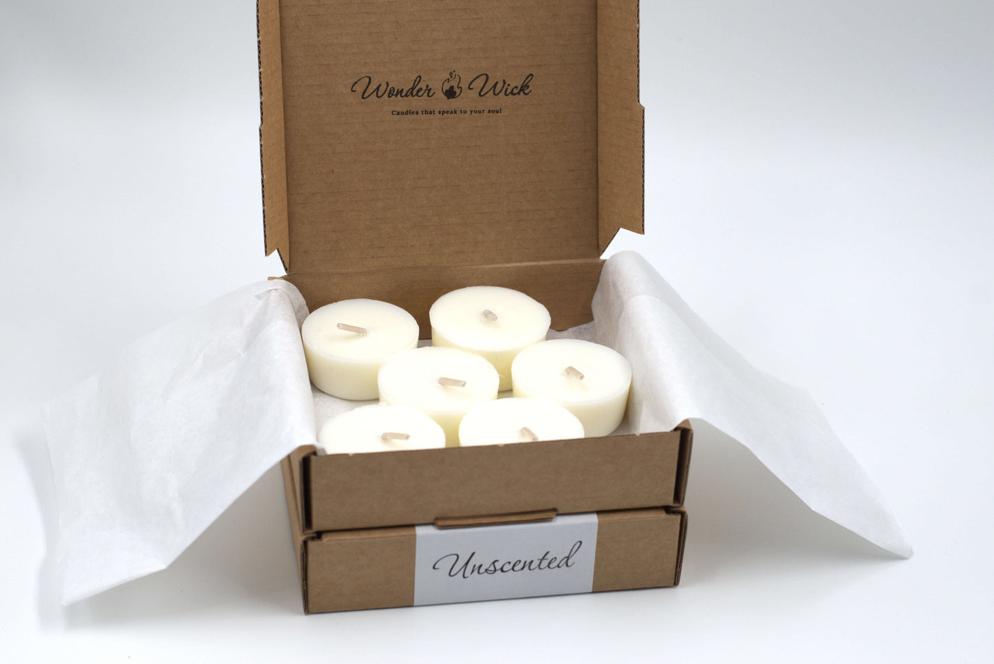 Six-pack of unscented tea light candles in a cardboard box with shredded paper, ideal for refilling glass holders from Wonder Wick