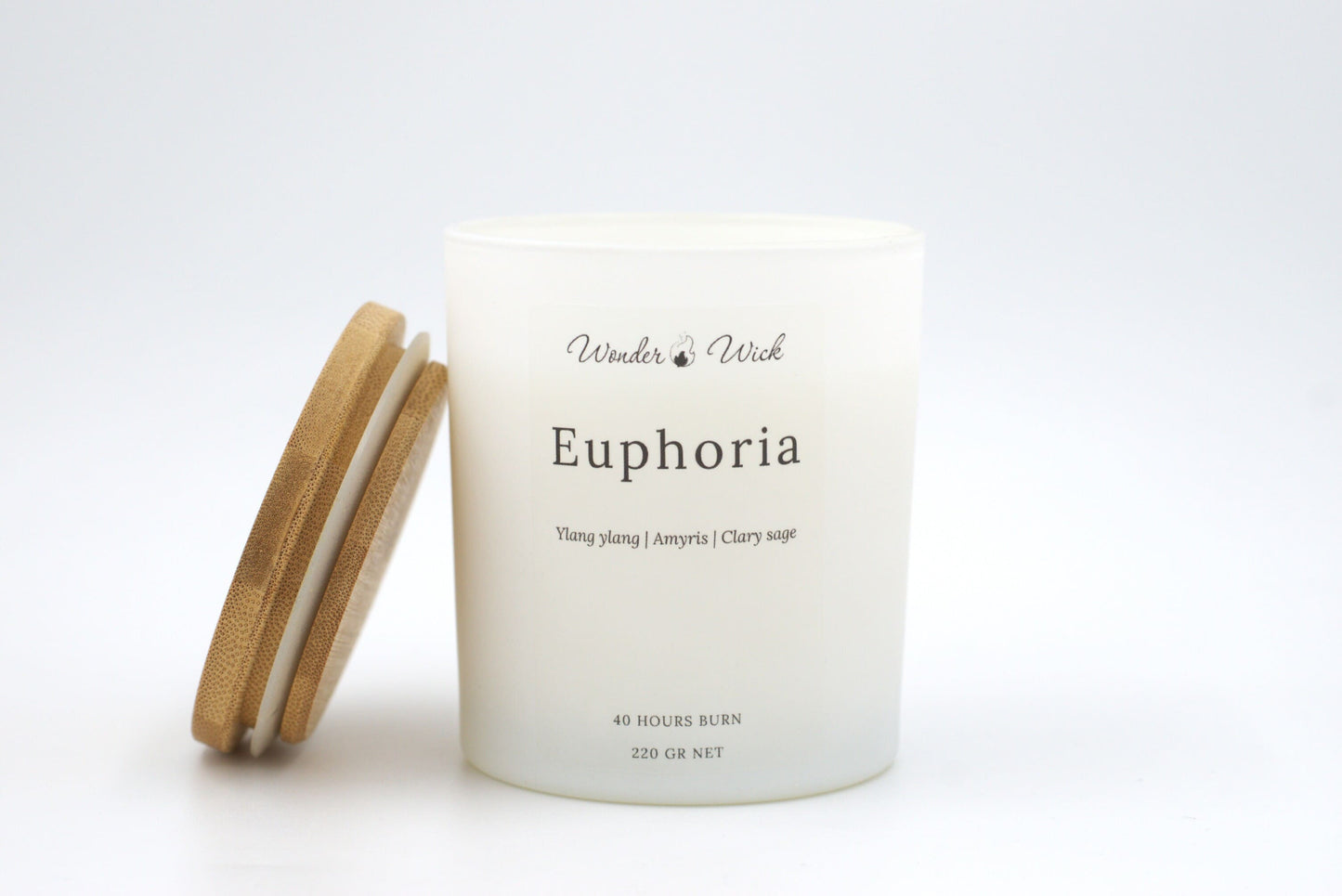 Euphoria 300 ml candle in white matte glass with bamboo lid beside it, featuring a soft floral and relaxing scent for intimate evenings and a 40 hour burn time. 