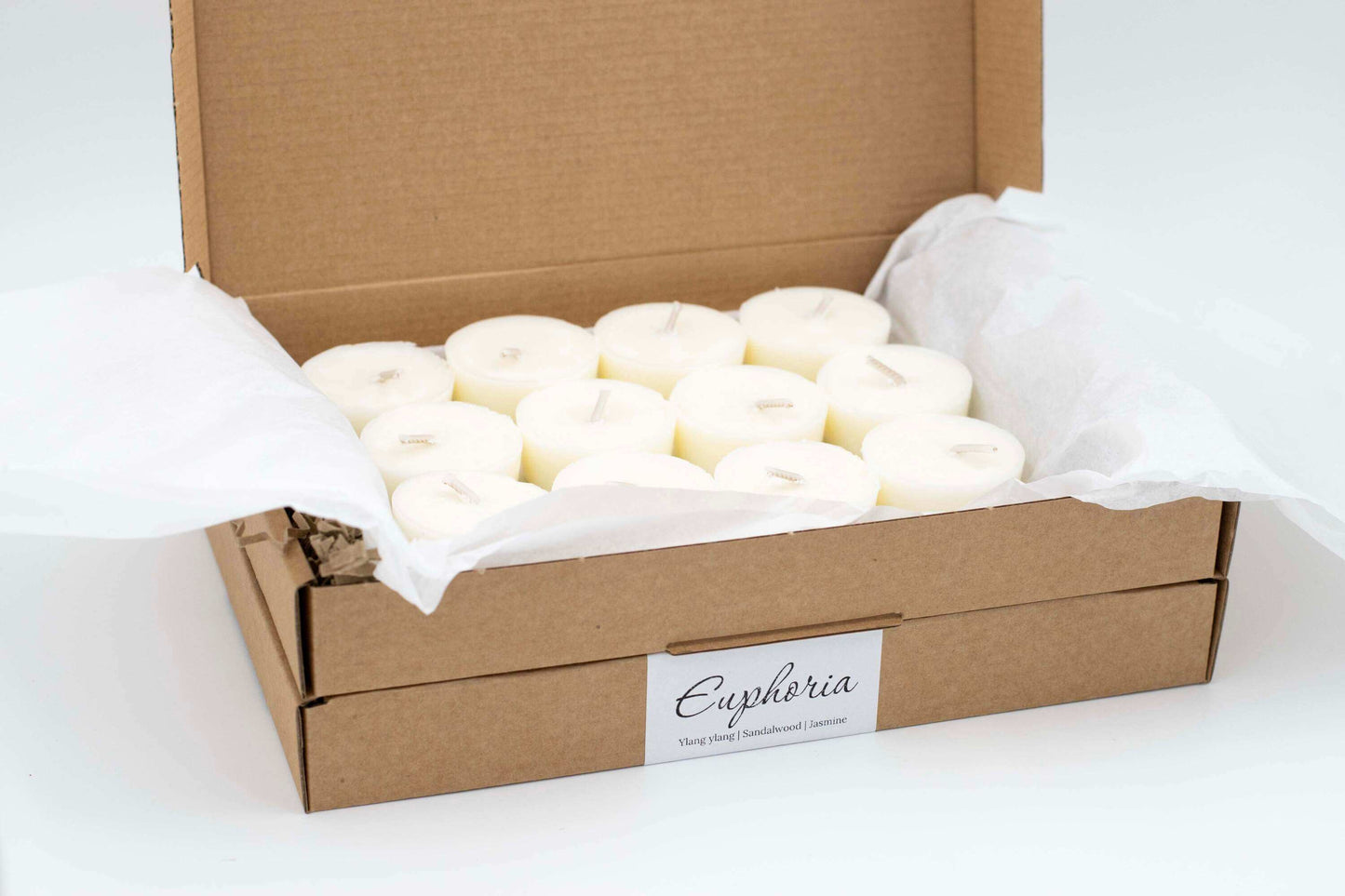 12-pack of Euphoria scented tea light candles with ylang-ylang, jasmine, and sandalwood, natural and refillable, packaged in an eco-friendly cardboard box.