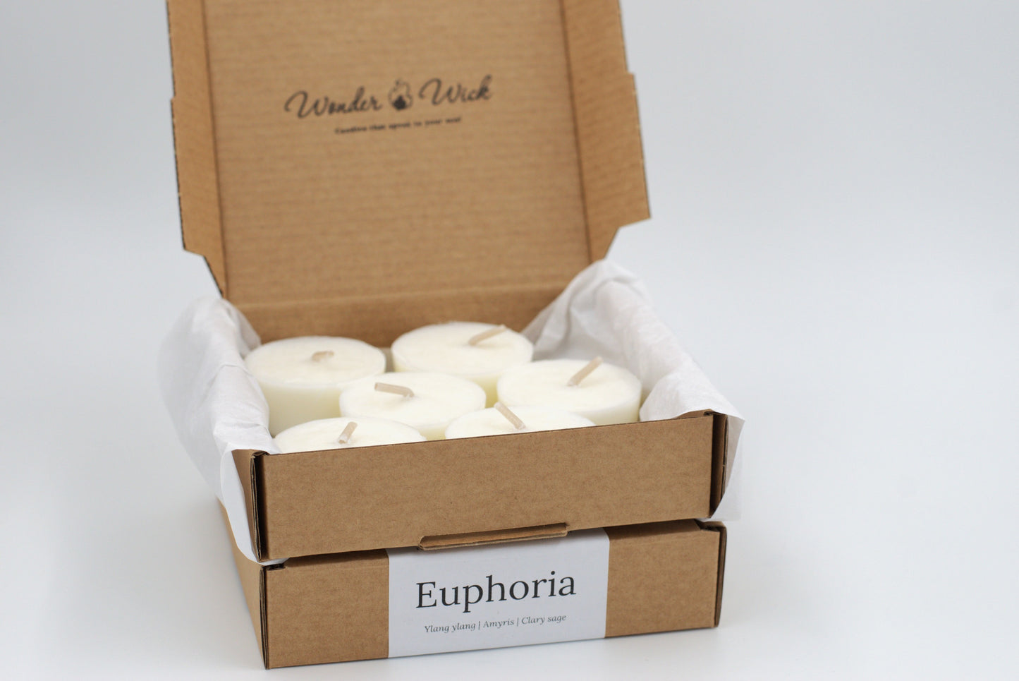 Euphoria tealight refills, pack of 6, in a cardboard box. Handcrafted with pure essential oils, including ylang ylang, amyris, and clary sage, for a soothing and romantic fragrance.