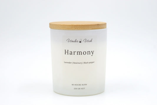 A 40-hour burn Harmony candle with the bamboo lid on, emphasizing its sustainable design and relaxing scent blend of lavender, rosemary, and black pepper. Perfect for moments of calm and de-stressing.