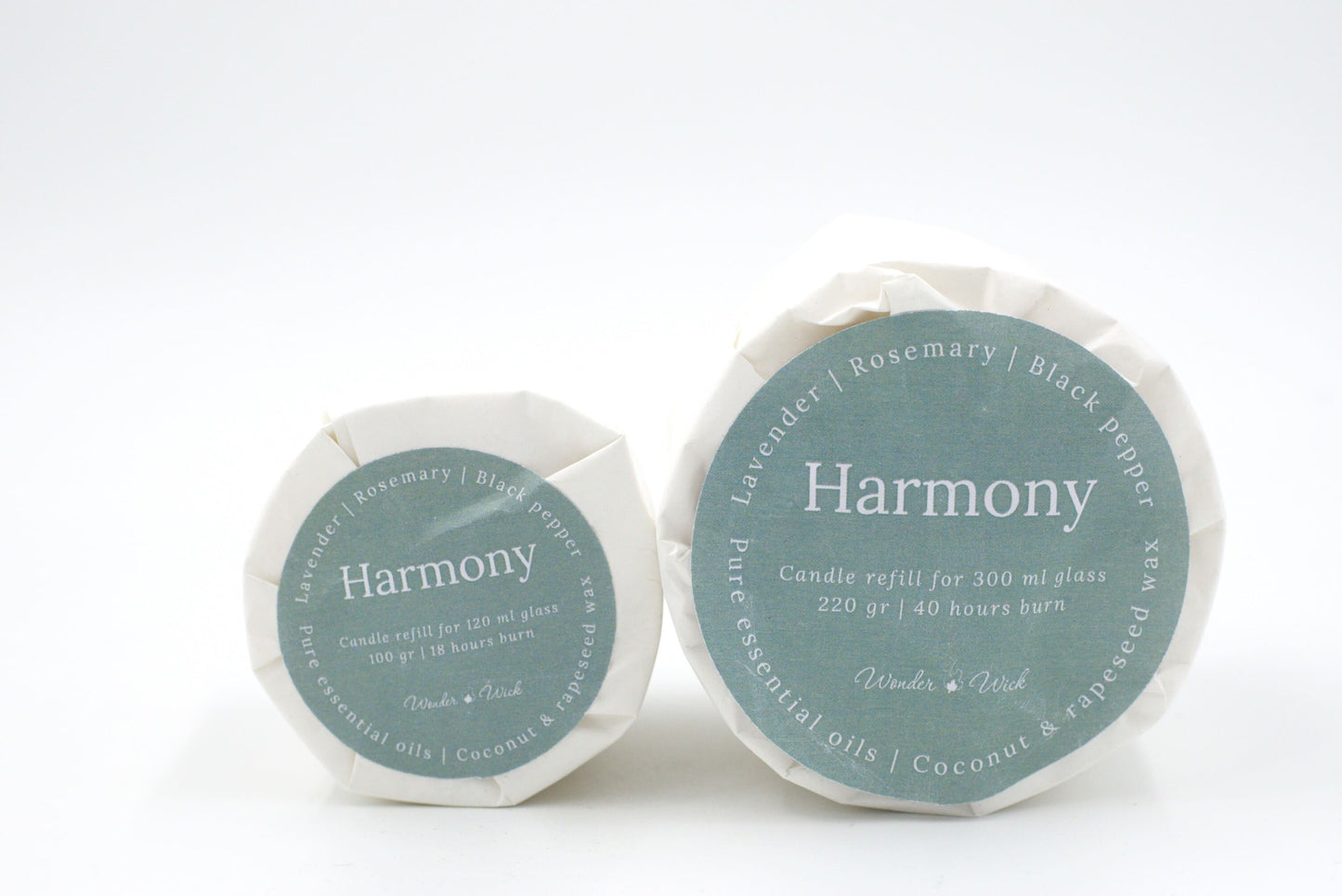 Harmony candle refills in two sizes: 120 ml and 300 ml options, labeled with lavender, rosemary, and black pepper essential oils, wrapped in sustainable glassine paper.