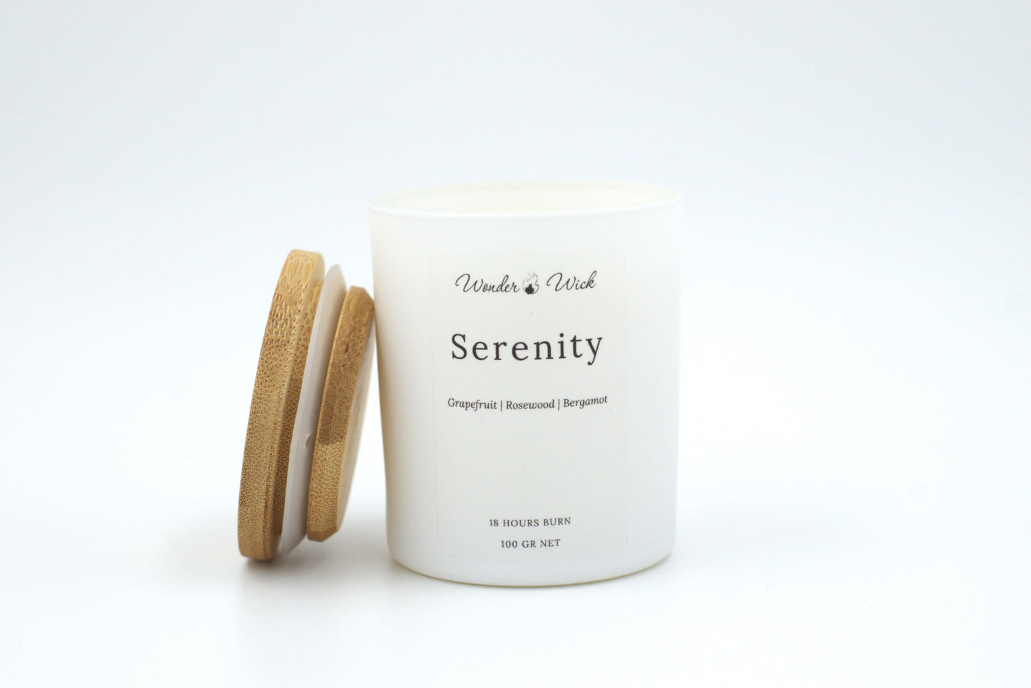 Serenity candle 100g with bamboo lid slightly open, showing refreshing grapefruit, bergamot, and rosewood scent.