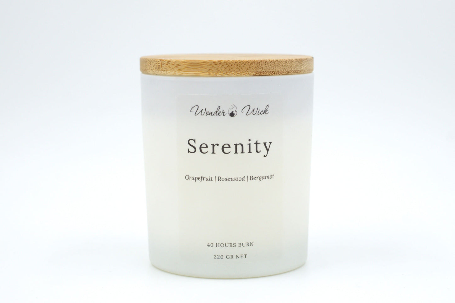 Serenity 220g candle with bamboo lid on, designed to uplift and refresh with notes of grapefruit, bergamot, and rosewood.