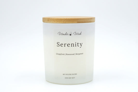 Serenity 220g candle with bamboo lid on, designed to uplift and refresh with notes of grapefruit, bergamot, and rosewood.