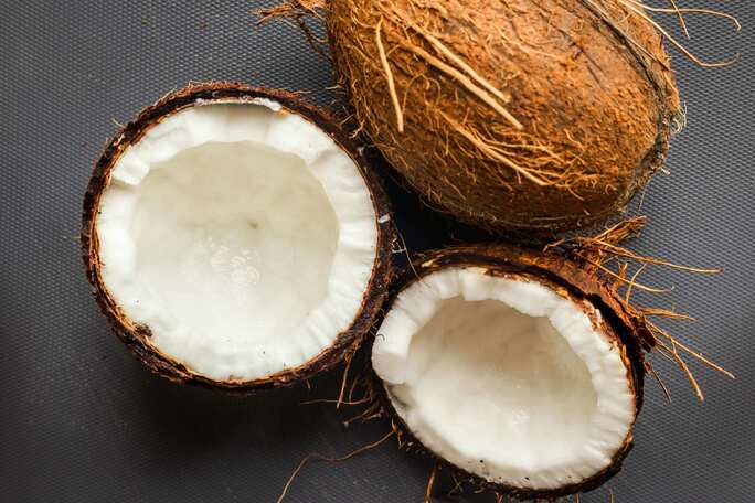 Close-up of a coconut split open, illustrating the natural, sustainable source of coconut wax used in Wonder Wick candles for a clean and eco-friendly burn
